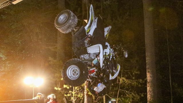 Einsatzkräfte der Polizei und Feuerwehr laden an einer Unfallstelle ein Quad auf einen Abschleppwagen: Eine 17-Jährige verlor bei dem Unfall ihr Leben.