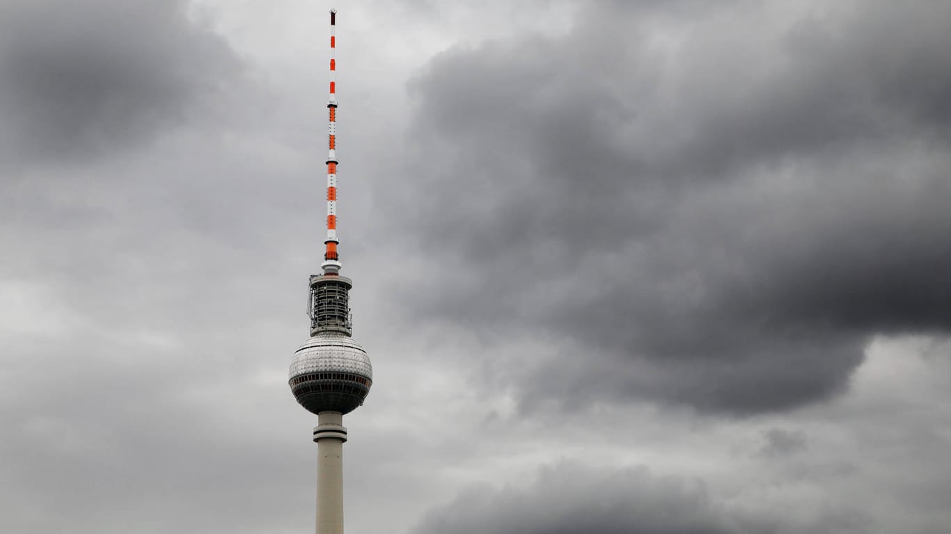 Dunkle Wolken über dem Fernsehturm (Symbolbild): Nach de frühlingshaften Wetter wird es in Berlin wieder winterlich.