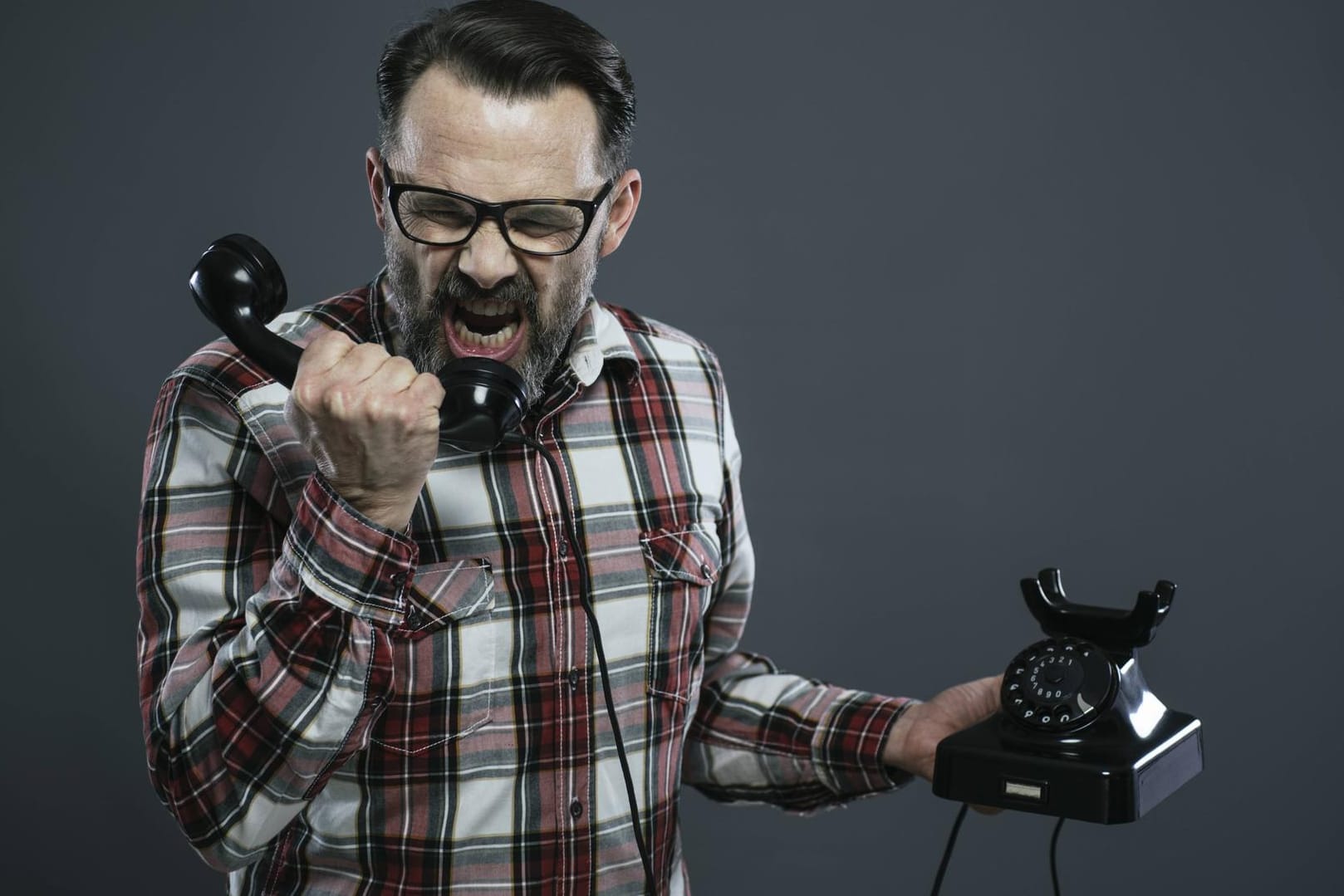 Ein wütender Mann am Telefon (Symbolbild): Spamanrufe können nerven.