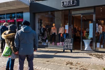 Kieler stehen vor einem für die Abholung geöffneten Geschäfts in der Innenstadt (Archivbild): Die Stadt setzt bei der Öffnung des Einzelhandels und der Gastronomie auch auf die Luca-App.