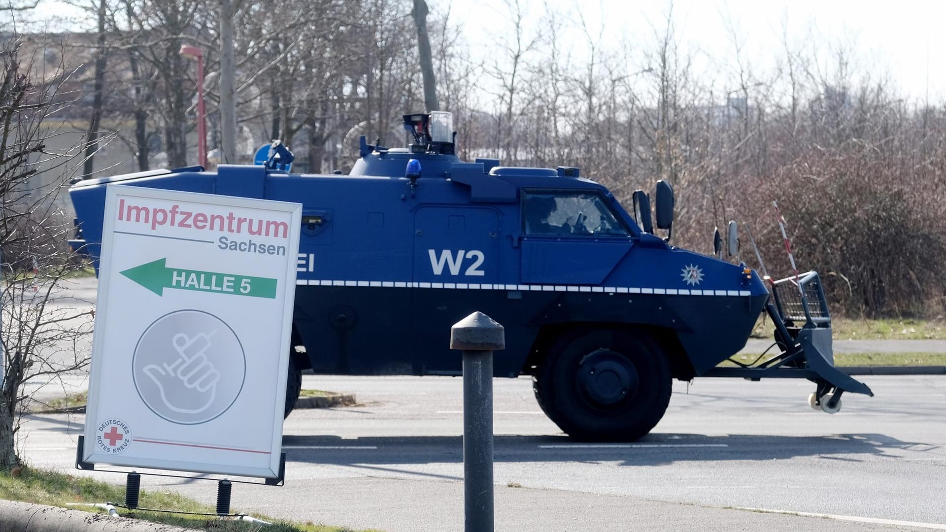 Ein gepanzertes Fahrzeug der Polizei fährt an der Leipziger Messe entlang, in der sich ein Impfzentrum befindet: Wegen Demos gegen die Corona-Maßnahmen und geplanten Gegenaktionen hatte sich die Polizei auf einen Großeinsatz vorbereitet.