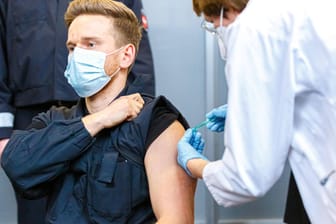 Ein Polizist wird in Hannover mit Astrazeneca geimpft: Die Stiko klagt, dass viele Bundesländer die Impfreihenfolge missachten.