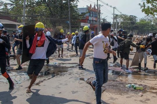 Anti-Putsch-Demonstranten ziehen sich von den behelfsmäßigen Barrikaden zurück, nachdem Bereitschaftspolizisten Schallbomben und Gummigeschosse abgefeuert hatten.
