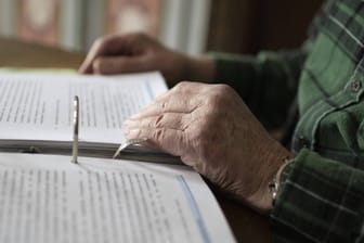 Älterer Mann mit einem Aktenordner (Symbolbild): Verbraucher können Einspruch gegen ihren Steuerbescheid einlegen.