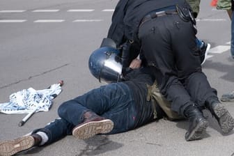 Ein Teilnehmer einer Demonstration von Rechtsextremisten und sogenannten Reichsbürgern wird von der Polizei am Brandenburger Tor in Berlin festgenommen.