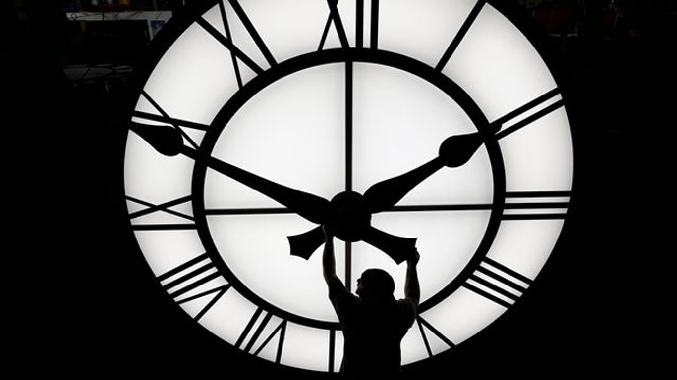 Zeitumstellung: Ein Techniker bewegt die Zeiger einer Uhr mit einem Durchmesser von mehr als 3,5 Metern. (Symbolbild)