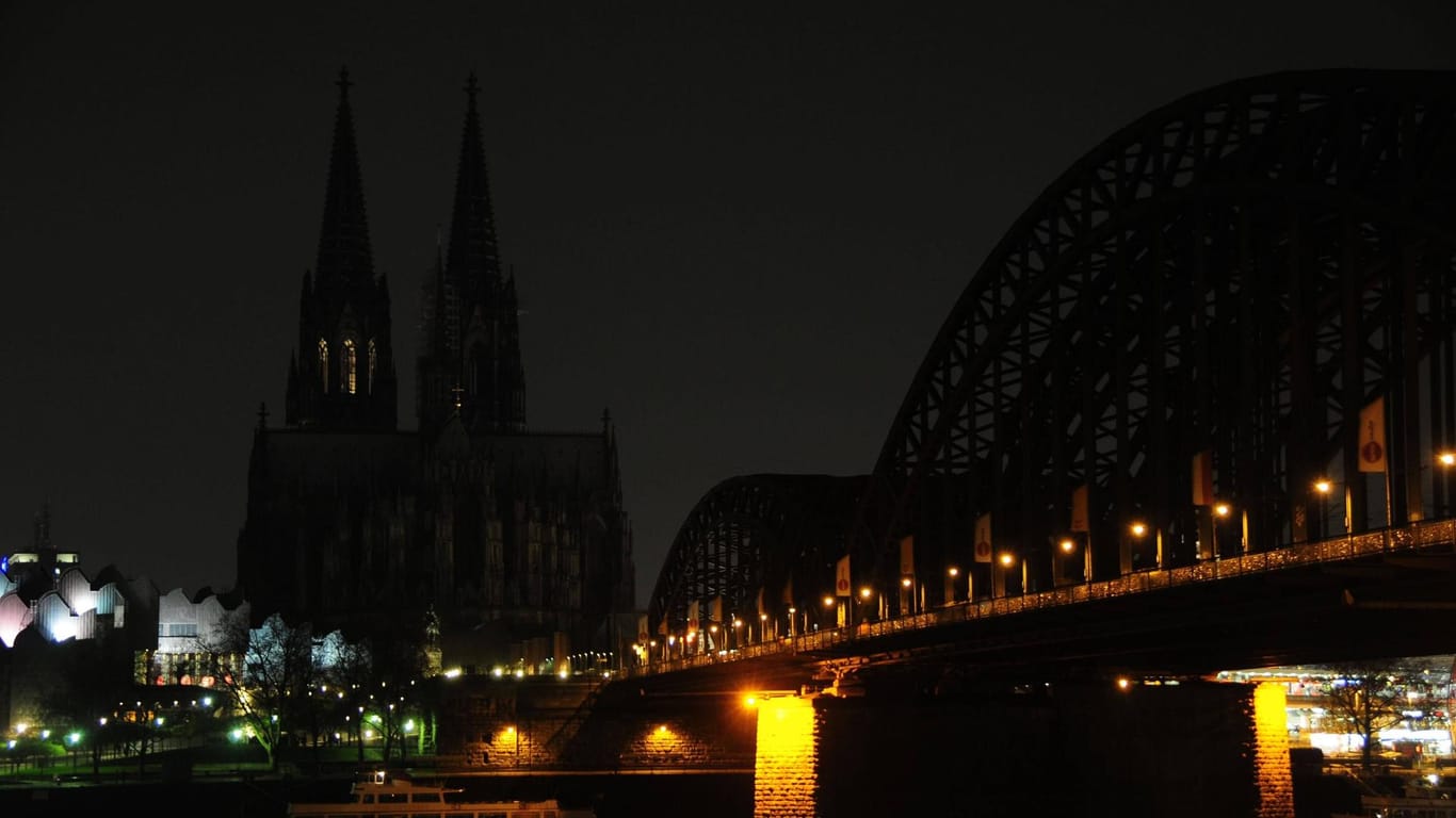 Kölner Dom und Hohenzollernbrücke im Dunkeln (Archivbild): Bei der "Earth Hour" geht am Samstag wieder für eine Stunde das Licht in der Stadt aus.