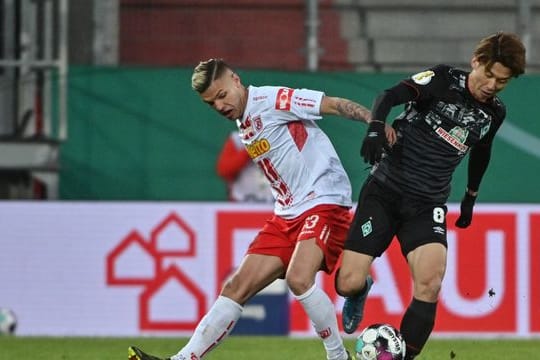 Regensburgs Jan Elvedi und Bremens Yuya Osako (r) kämpfen um den Ball.