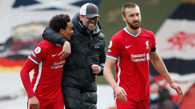 Liverpools Trainer Jürgen Klopp (M) umarmt Trent Alexander-Arnold (l) nach dem Spiel.