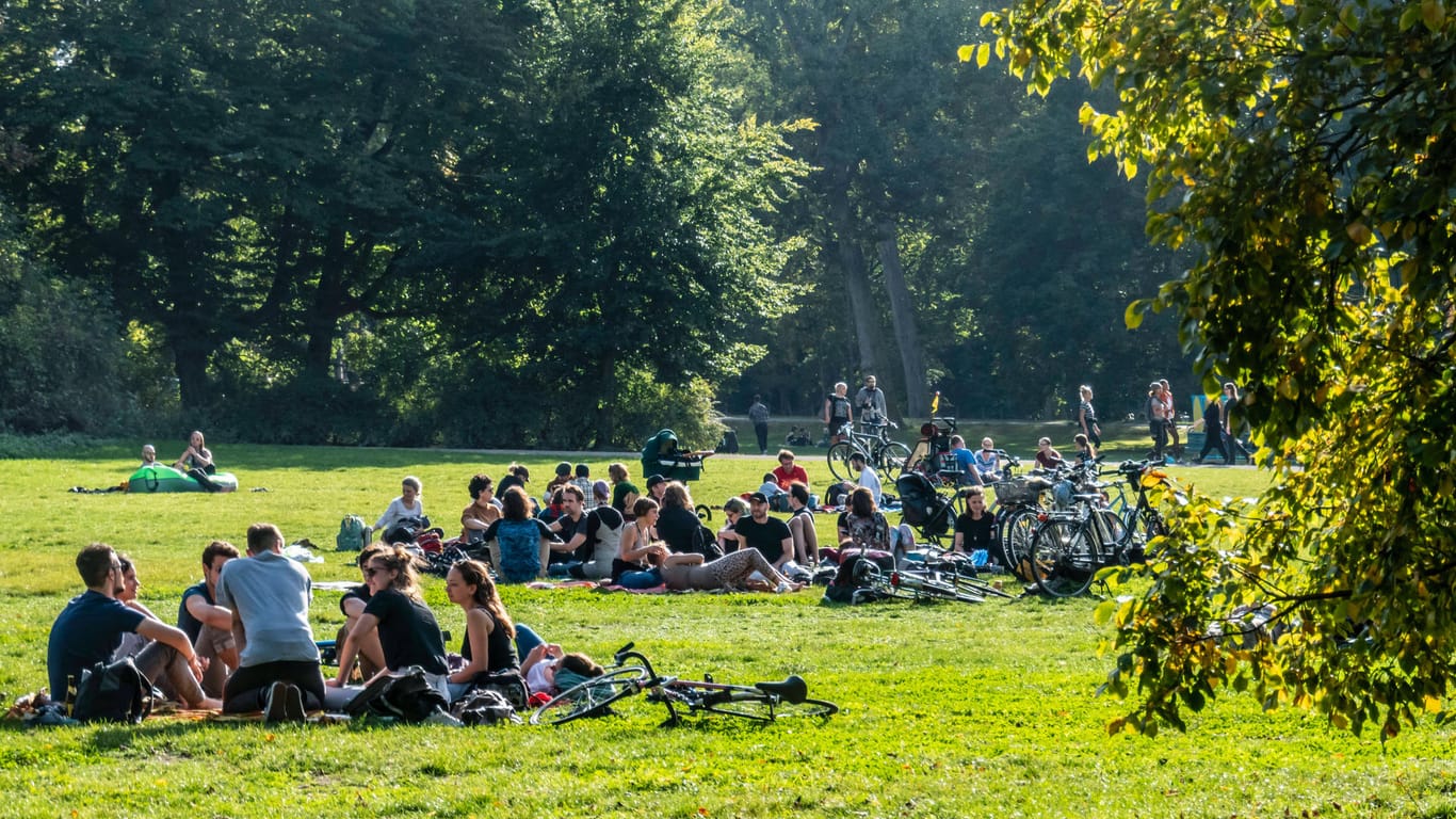 Menschen sitzen in einem Park (Symbolbild): In Karlsruhe hat die Polizei mehrere Verstöße gegen die Corona-Regeln festgestellt.