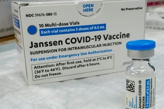 Eine Ampulle und eine Verpackung des Corona-Impfstoffs von Johnson & Johnson.