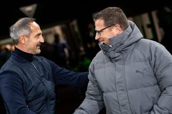 Frankfurts Trainer Adi Hütter (l) und Gladbachs Sportdirektor Max Eberl begrüßen sich vor der Partie ihrer beiden Clubs.