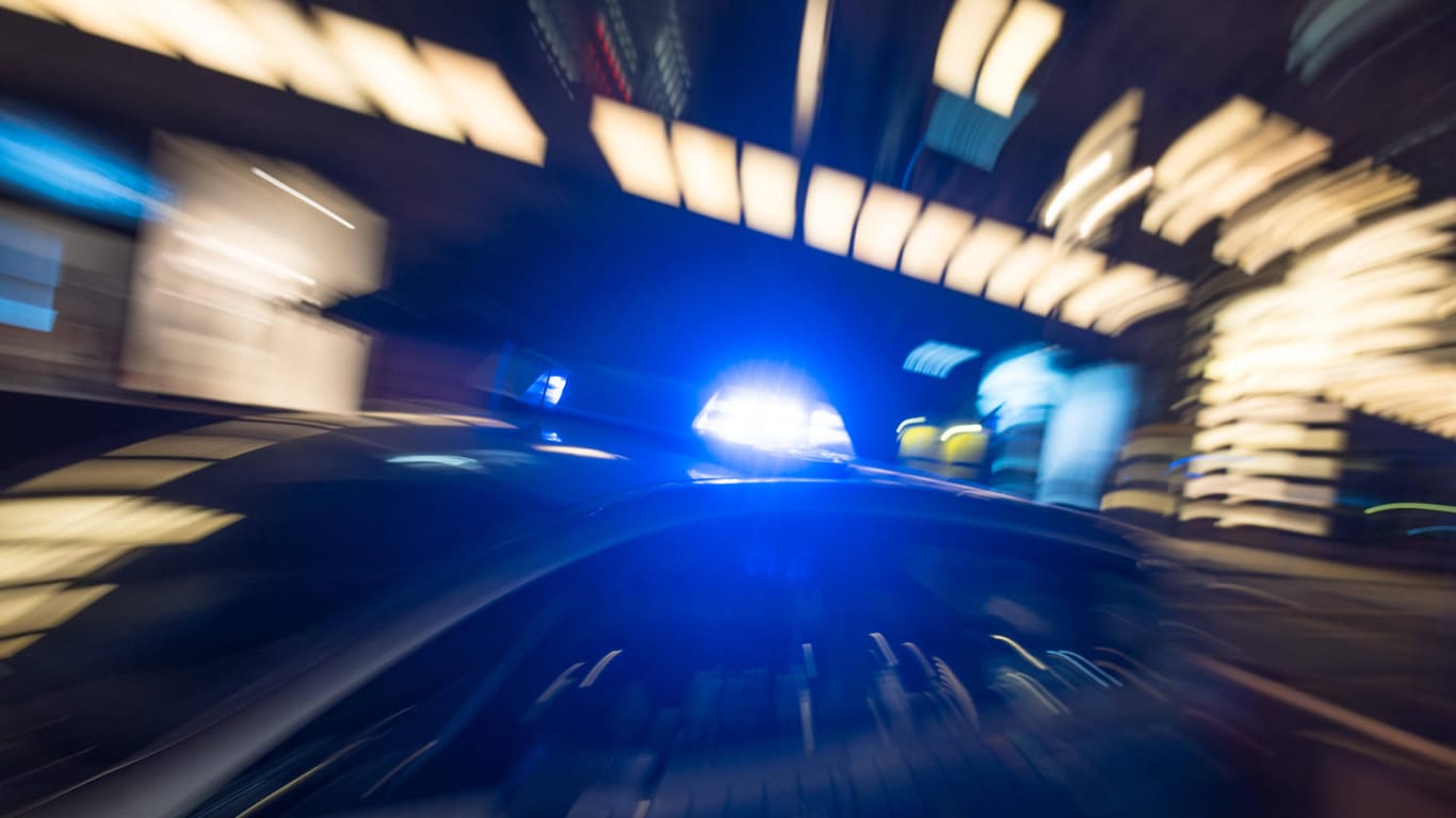 Ein Polizeiauto mit eingeschalteten Blaulicht (Symbolbild): In Berlin sucht die Polizei mit Fotos nach einem mutmaßlichen Räuber.