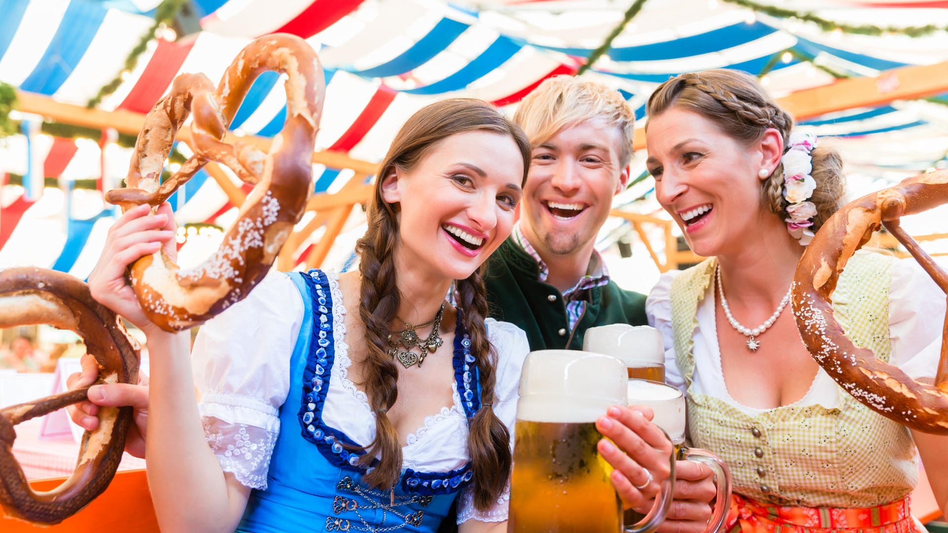 Friends with giant pretzels in Bavarian beer tent