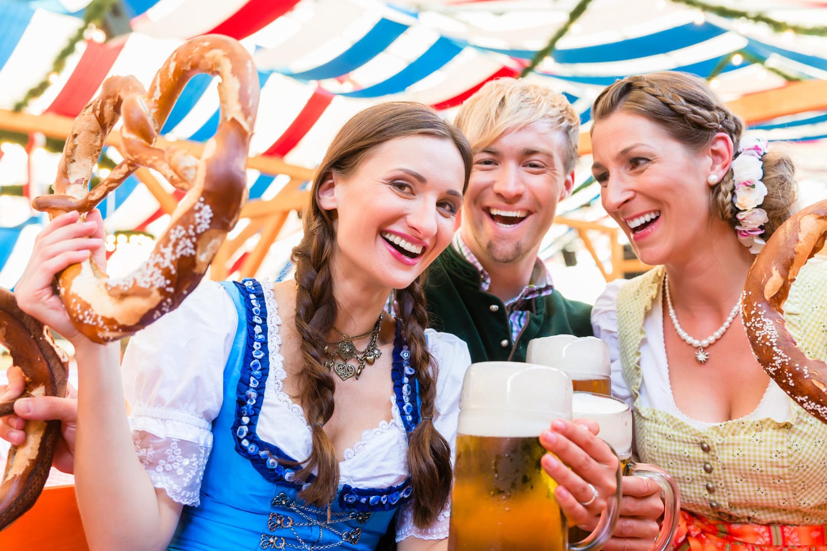 Friends with giant pretzels in Bavarian beer tent