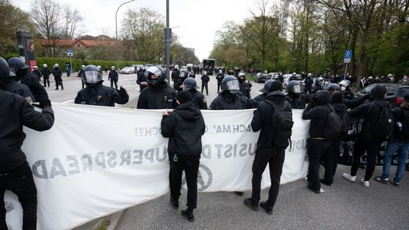 Polizisten stehen am U-Bahnhof Schlump Demonstranten gegenüber: Zu der Demo sollen mehr als die erlaubten 50 Teilnehmenden gekommen sein.