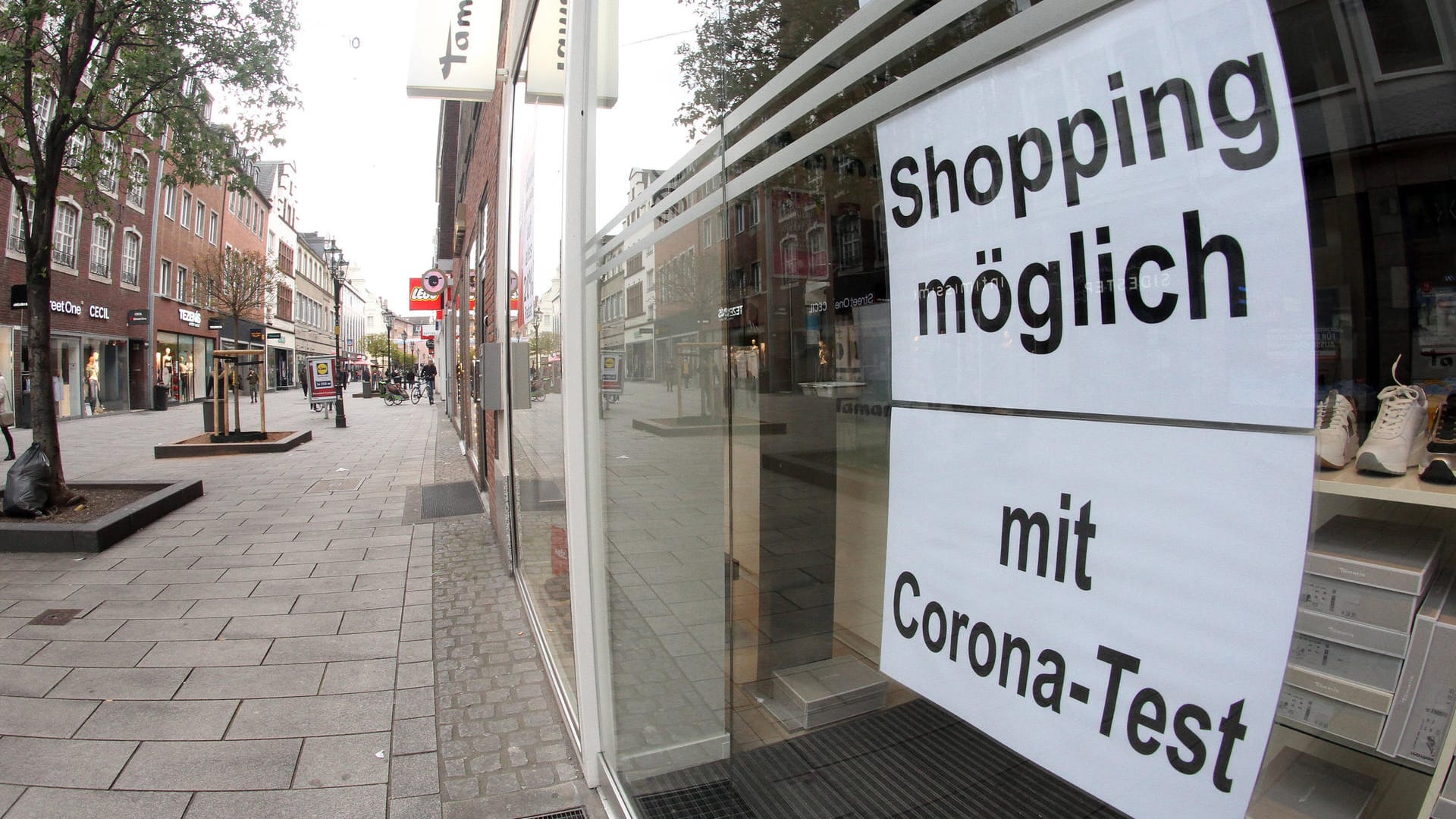 Schriftzug "Einkaufen möglich mit negativem Coronatest" klebt in einem Schaufenster eines Modegeschäfts in der Fußgängerzone (Symbolbild): Ab Samstag darf Termin-Shopping wieder stattfinden. Schriftzug "Einkaufen möglich mit negativem Coronatest" klebt in einem Schaufenster eines Modegeschäfts in der Fußgängerzone (Symbolbild): Ab Samstag darf Termin-Shopping wieder stattfinden.