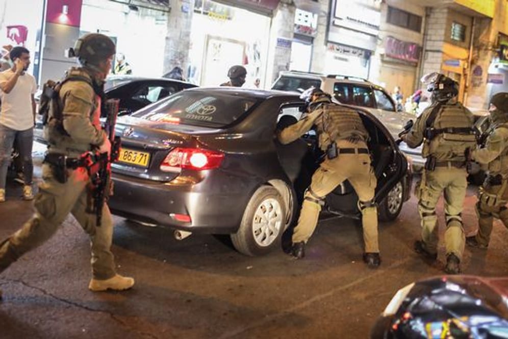 Israelische Sicherheitskräfte durchsuchen ein Auto während einer Demonstration gegen den geplanten Räumungsprozess im Stadtteil Scheich Dscharrah.