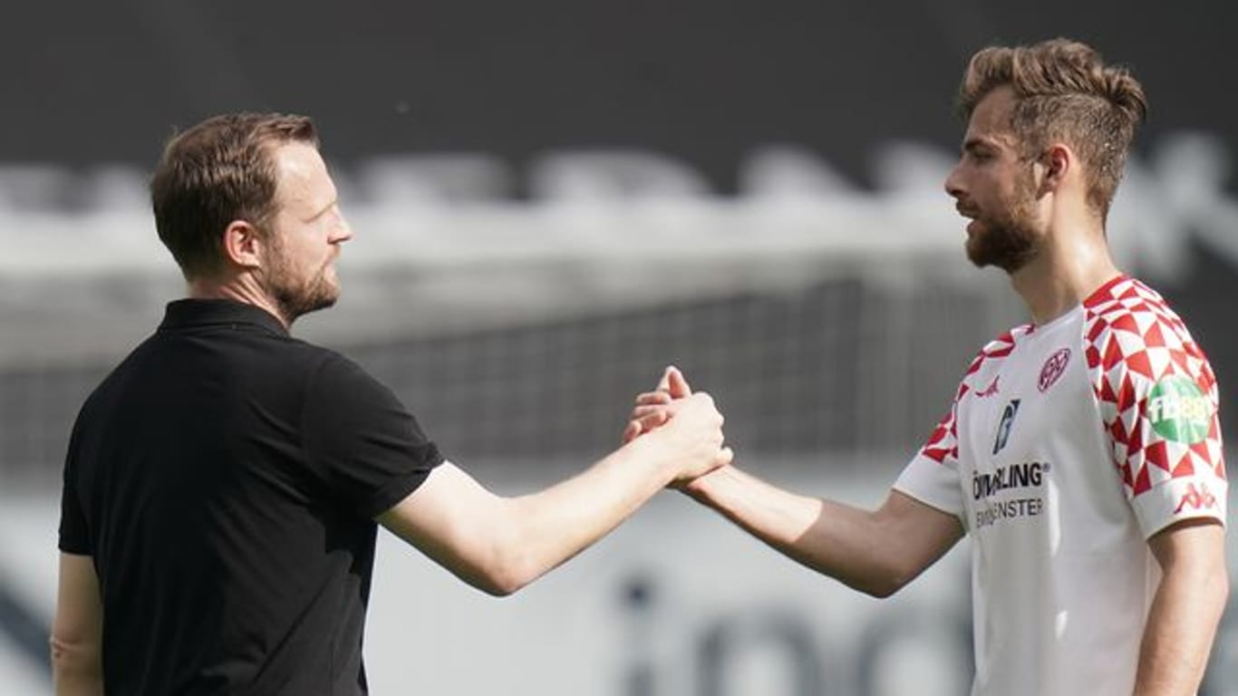 Mainz-Trainer Bo Svensson (l) klatscht nach dem Spiel mit Abwehrspieler Alexander Hack ab.