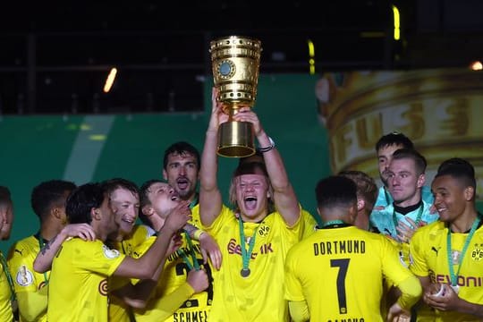 Dortmunds Top-Stürmer Erling Haaland hebt den Pokal in die Höhe.