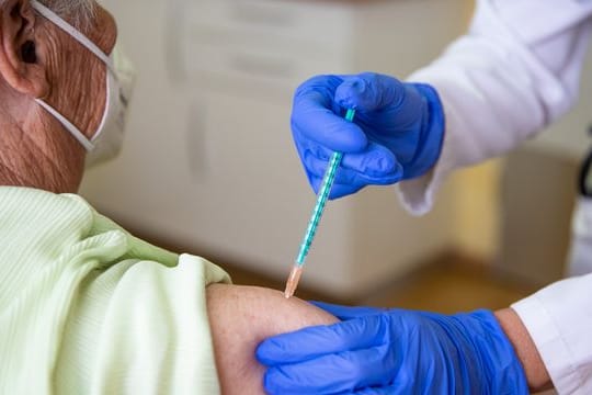 Eine Fachärztin für Allgemeinmedizin impft in ihrer Praxis eine Patientin gegen das Coronavirus.