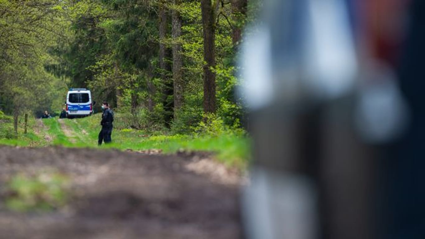 In einem Waldstück unweit von Bispingen sperren Polizisten den Fundort einer Kinderleiche ab.