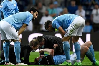 Man Citys Kevin De Bruyne wird nach einer Kollision mit Chelseas Rüdiger auf dem Spielfeld medizinisch behandelt.