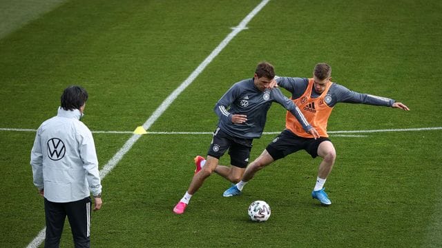 Bundestrainer Joachim Löw (l) beobachtet einen Zweikampf zwischen Thomas Müller und Matthias Ginter (r).