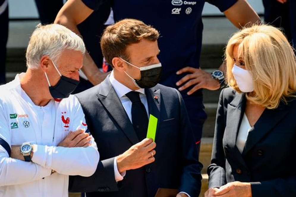 Hoher Besuch: Emmanuel Macron (M) und Gattin Brigitte stattete Nationalcoach Didier Deschamps (l) und seinem Team einen Besuch ab.