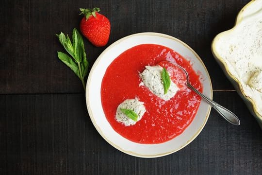 Mit Mascarpone-Minz-Eis in pürierten Erdbeeren lassen sich heiße Sommertage versüßen.