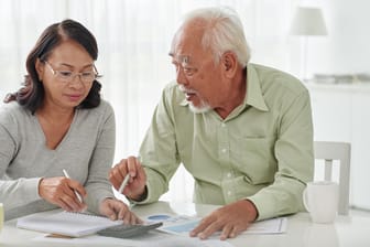 Senioren-Paar sortiert Unterlagen (Symbolbild): Nicht jeder Rentner muss eine Steuererklärung abgeben.