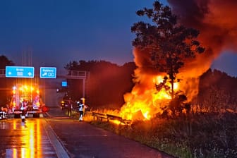 Rechts neben der A1 steigen am Sonntagabend Flammen und Rauch in den Himmel: Der Unfallwagen hatte nach seinem Überschlag Feuer gefangen.
