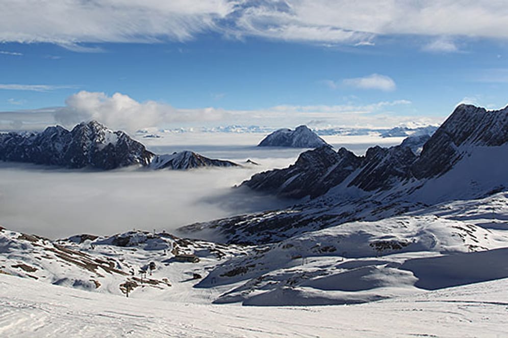 Berggipfel ragen vom Skigebiet der Zugspitze bei Grainau aus dem Nebel.