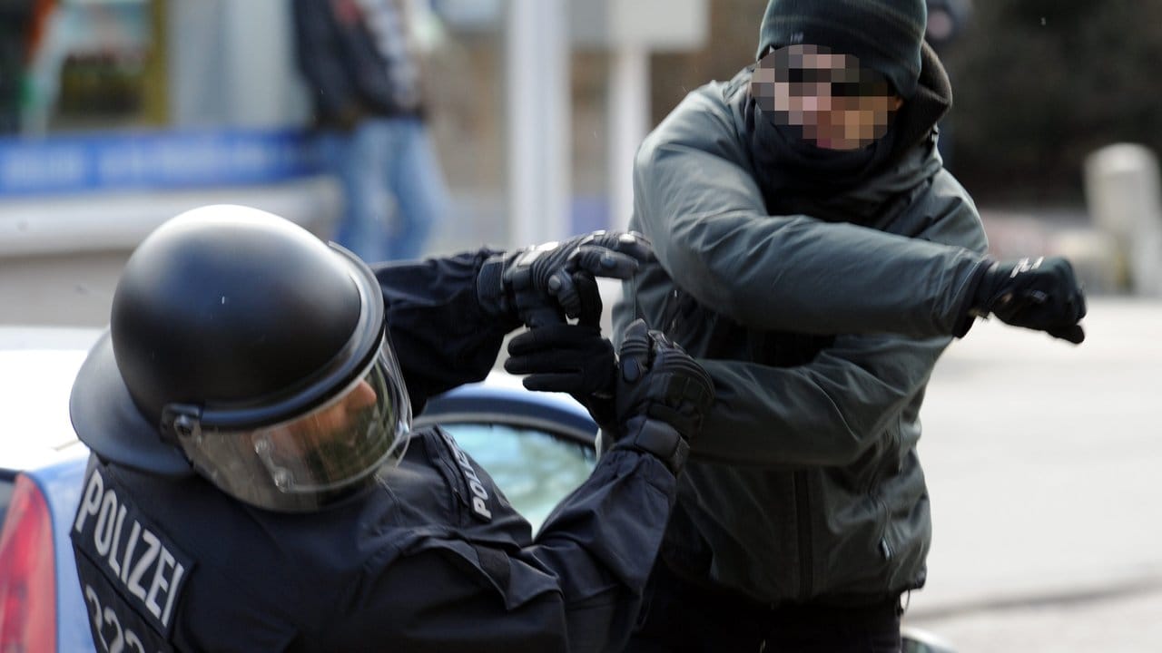 Ein gewalttätiger Demonstrant schlägt in Lübeck einen Polizeibeamten nieder.
