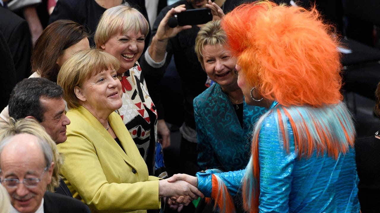 Bundeskanzlerin Angela Merkel begrüßt die Drag Queen Olivia Jones in Berlin im Plenarsaal des Reichstagsgebäudes.