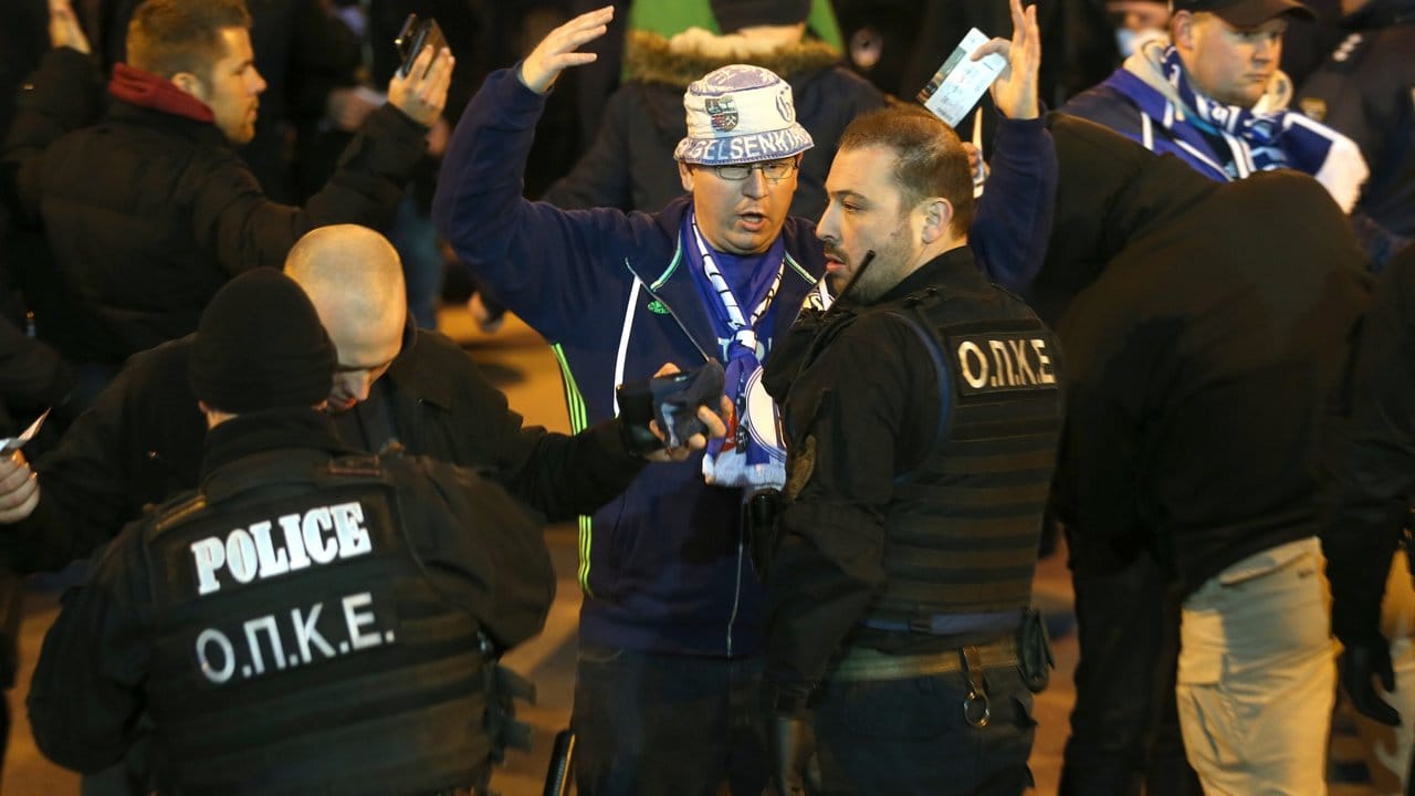 Polizisten kontrollieren in Thessaloniki Fans vom FC Schalke 04, die sie in Bussen zum Stadion fahren.