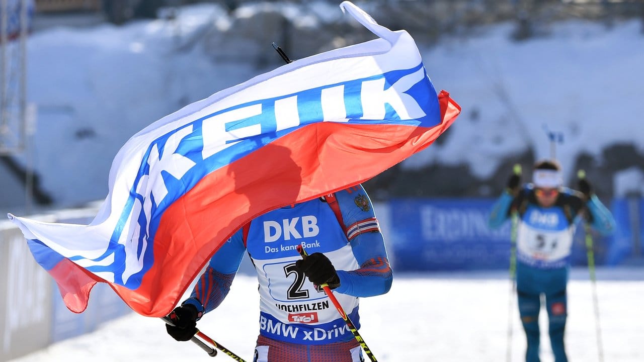 Russlands Schlussläufer Anton Schipulin (l) jubelt mit der Landesfahne im Ziel über WM-Gold.