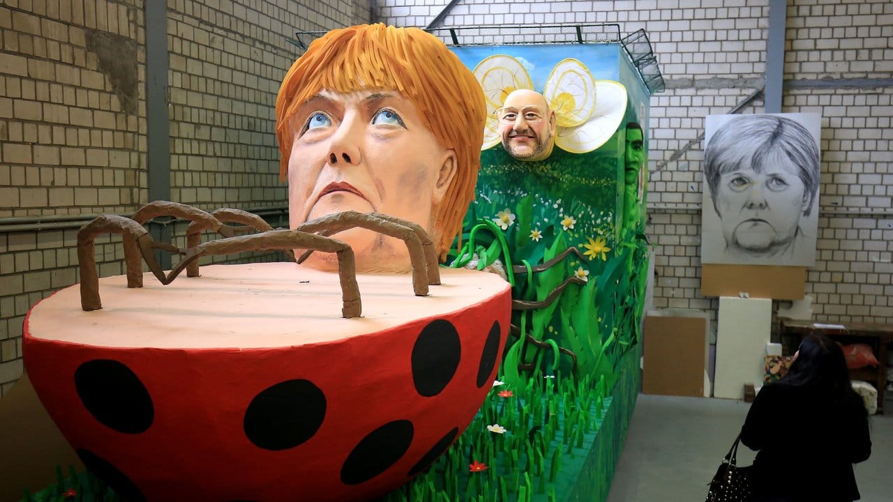 Dieses Jahr ist Bundestagswahl: Bundeskanzlerin Angela Merkel (CDU) liegt als Käfer auf dem Rücken, im Hintergrund "summt" der Kanzlerkandidat Martin Schulz (SPD).