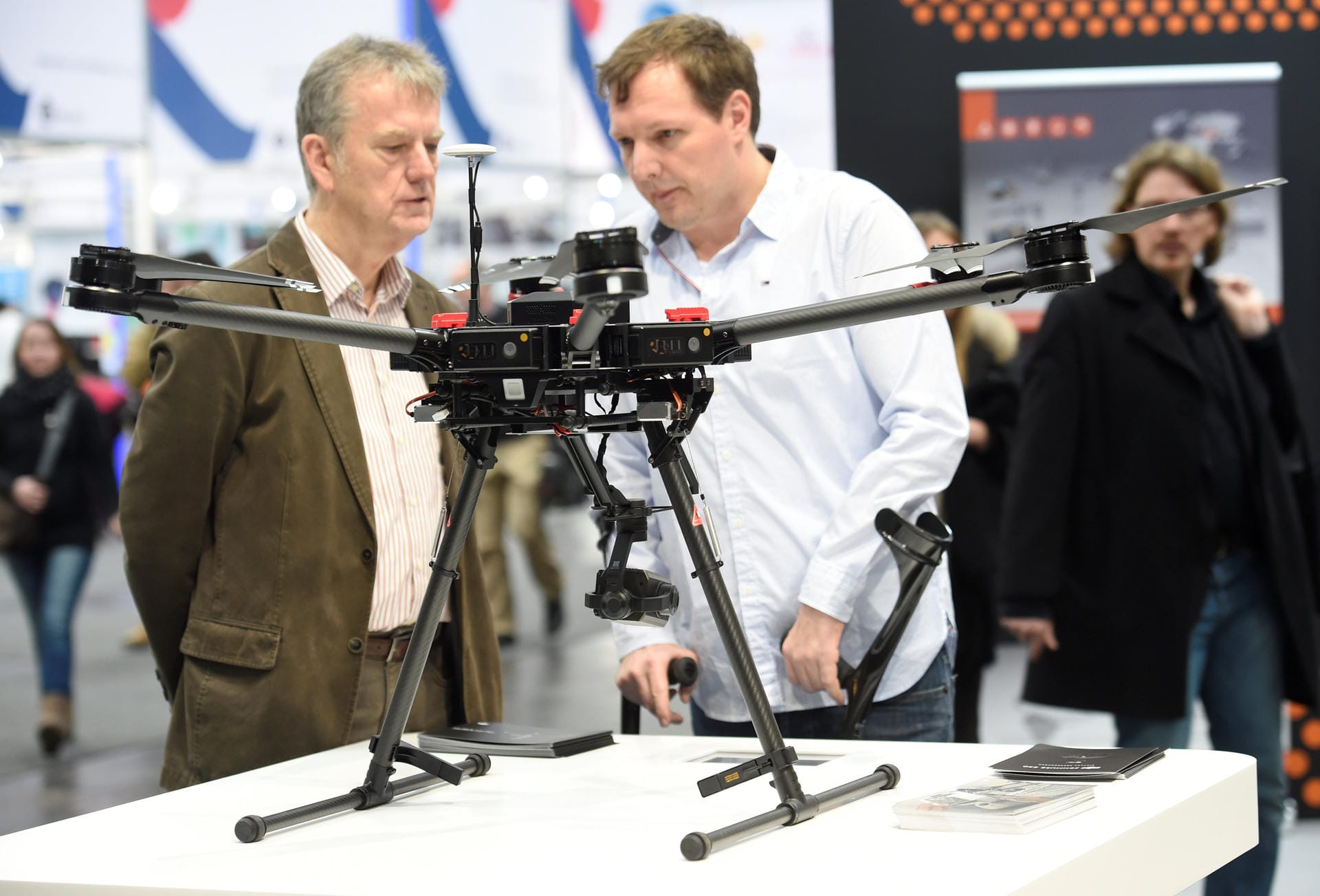 Visitors look at the drone Matrice 600 PRO at the booth of Chinese company DJI at the world's biggest computer and software fair, CeBit, in Hanover
