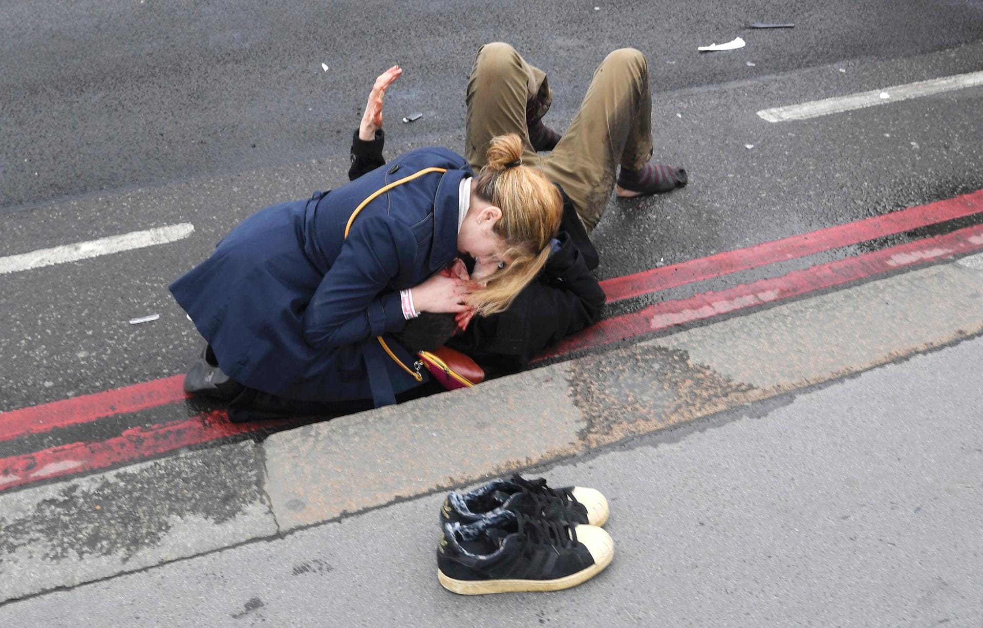 Zuspruch: Eine Frau hat sich auf der Westminster Bridge eines Verletzten angenommen.