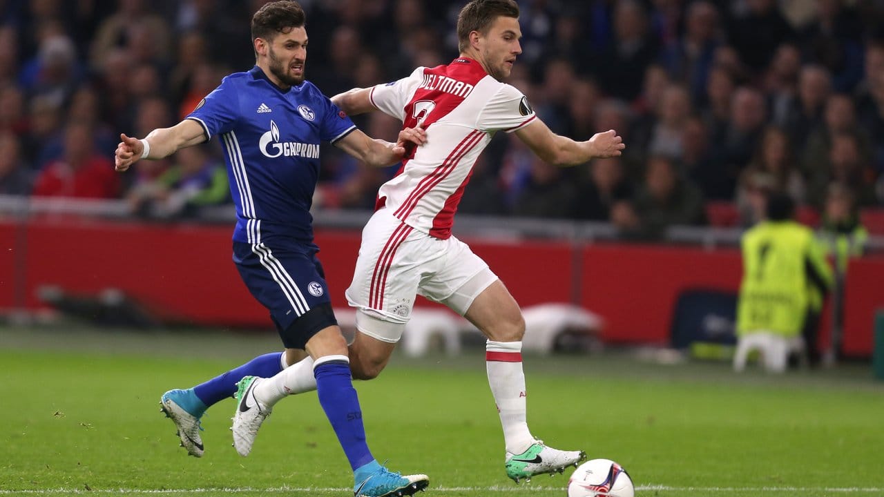 Der Schalker Daniel Caligiuri (l) und Joel Veltman (r) von Ajax Amsterdam kämpfen um den Ball.