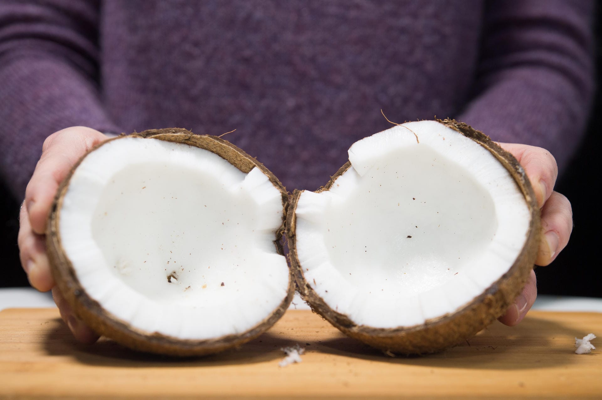 Kokosnuss: Schritt 4 – Ist die Schale geknackt, lässt sich die Kokosnuss in zwei Hälften aufklappen.