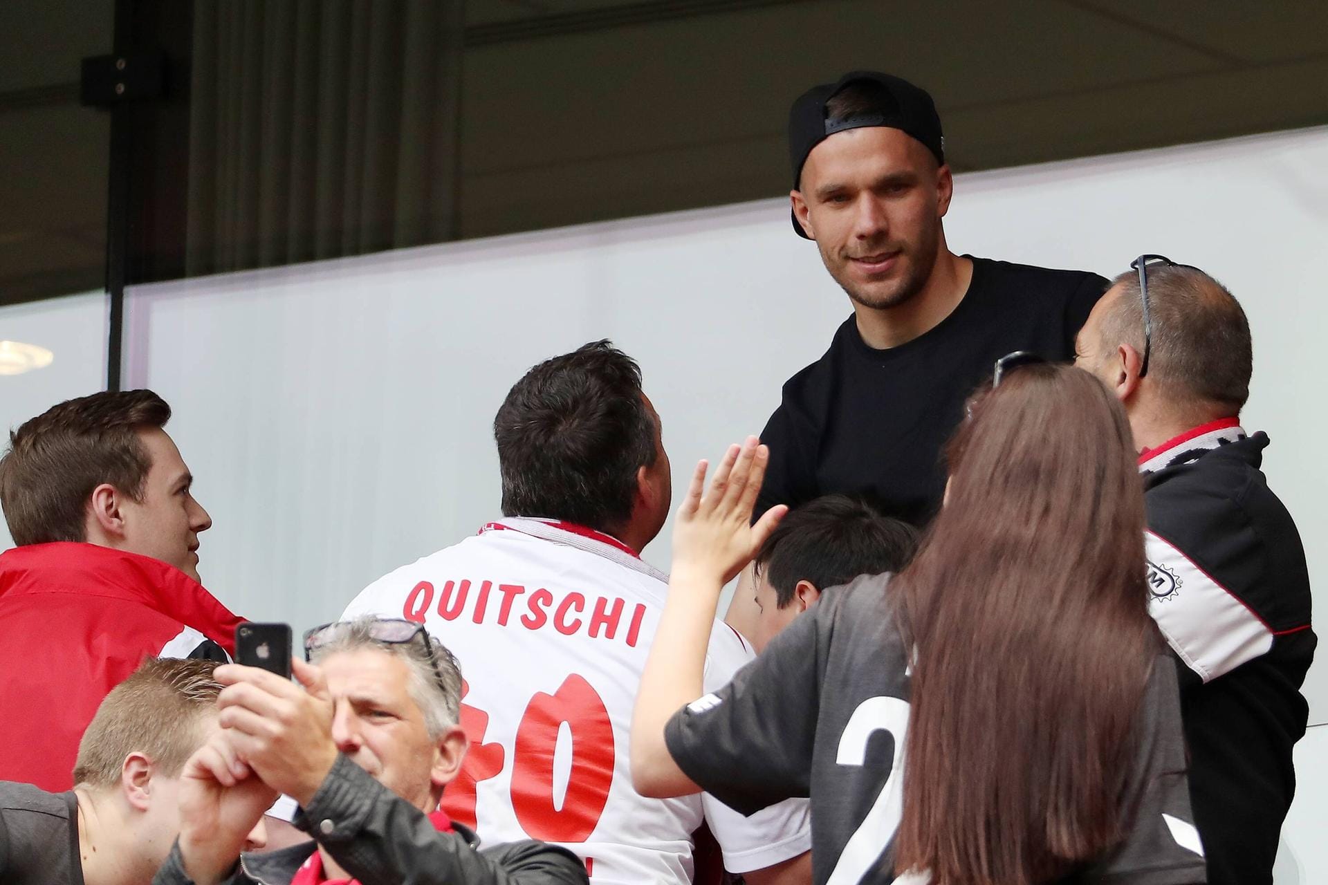 Hoher Besuch in Köln: Lukas Podolski schaut das Spiel gegen Mainz und gibt fleißig Autogramme.