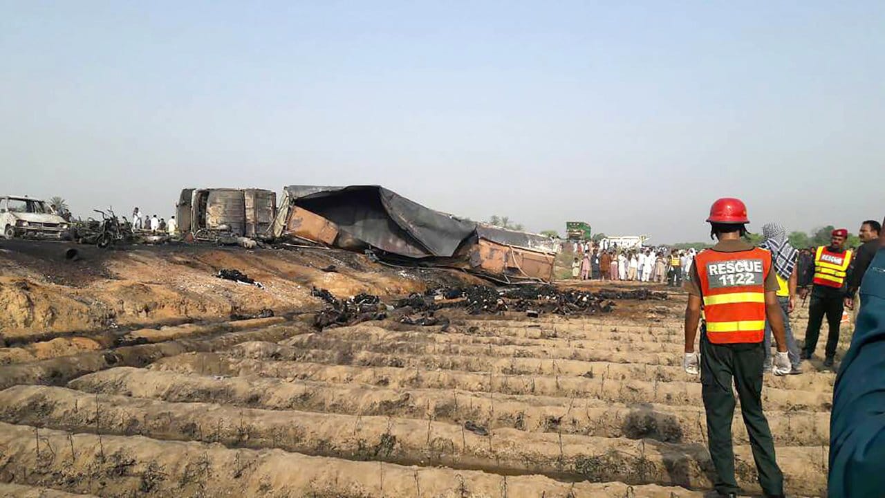 Rettungskräfte im pakistanischen Bahawalpur vor dem ausgebrannten Wrack des Tanklastzug.