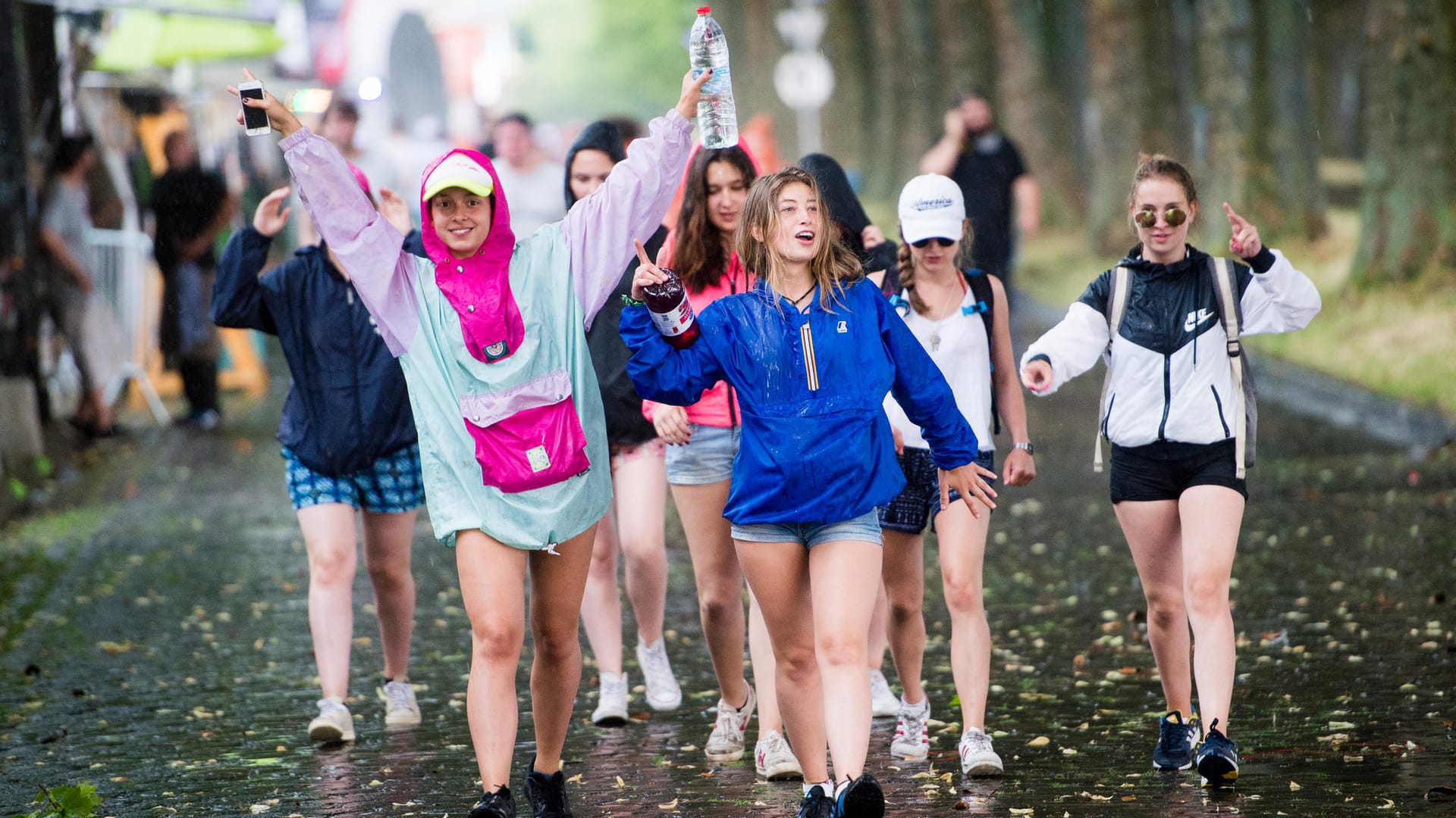 Junge Frauen feiern im Regen Junge Frauen feiern im Regen