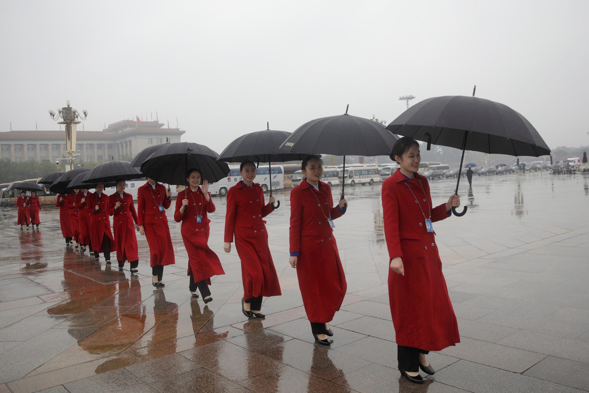 Hostesses are seen at the Tiananmen Square during the opening of the 19th National Congress of the Communist Party of China at the Great Hall of the People in Beijing