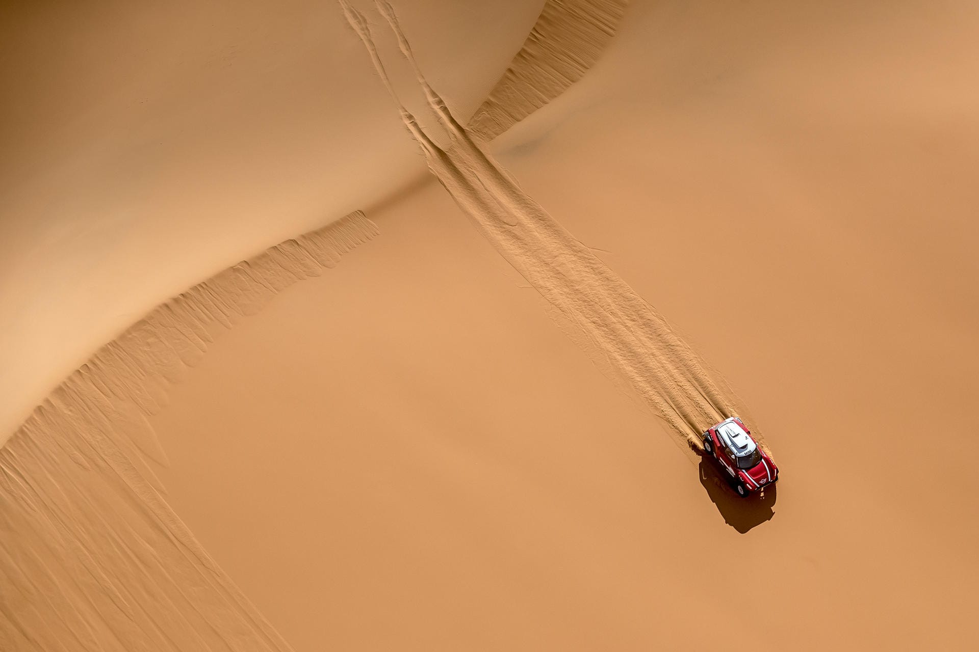 Die Rallye Dakar führt über Geröllfelder, Asphaltstrecken und auch durch Wüstensand.