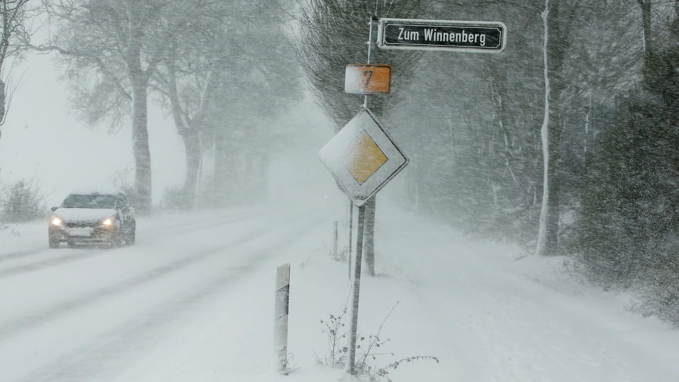 Bei starken Schneefällen kämpft ein Autofahrer am 10.12.2017 nahe der nordrhein-westfälischen Landeshauptstadt Düsseldorf auf der B7 mit den unwirtlichen Wetter- und Verkehrsverhältnissen.