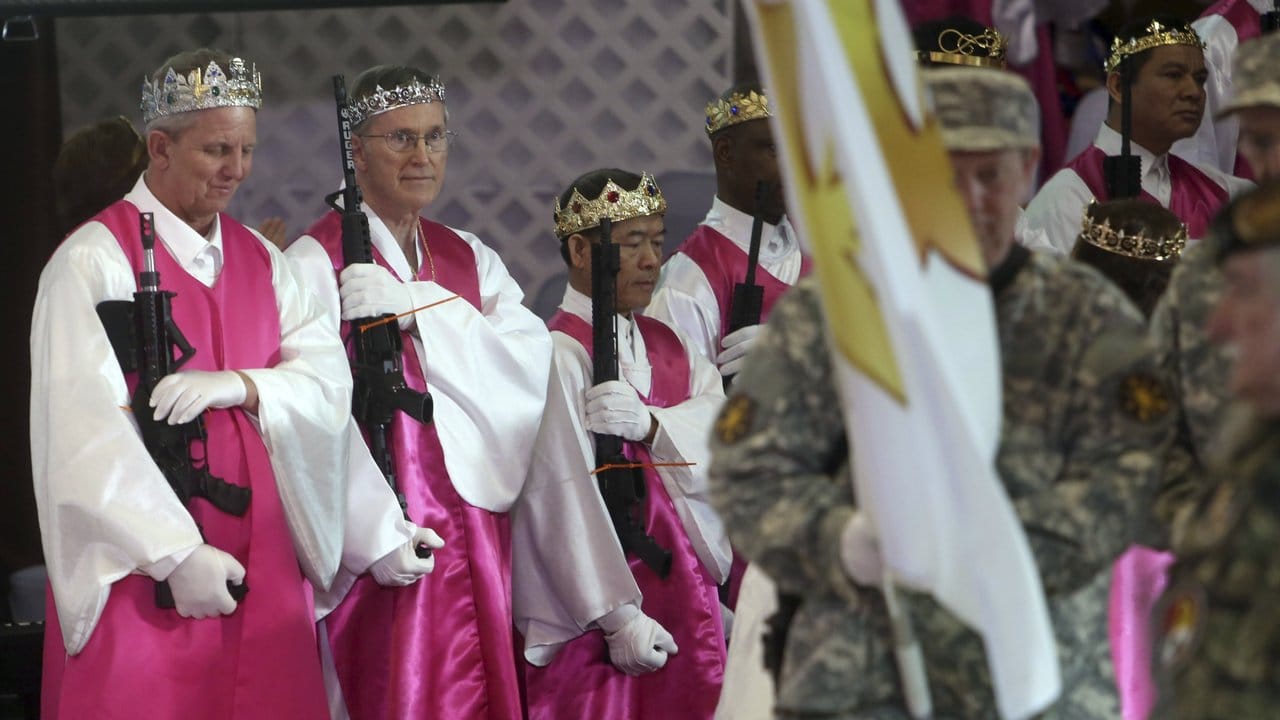 Kirchenmitglieder halten AR-15-Gewehre bei einem Gottesdienst in der Kirche World Peace and Unification Sanctuary.