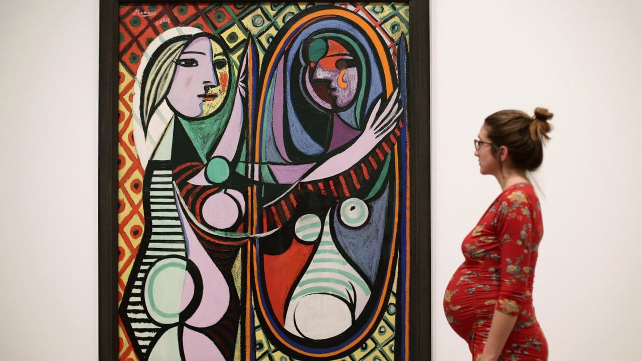 Das Gemälde "Mädchen vor dem Spiegel" (1932) von Pablo Picasso in der Tate Modern. Das Gemälde "Mädchen vor dem Spiegel" (1932) von Pablo Picasso in der Tate Modern.
